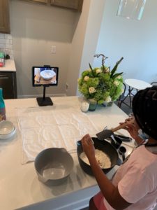 A Little learns to make bread with her mentee